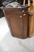 A Victorian oak cased corner cupboard having shelved interior