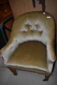 A Victorian oak frame easy chair having later dralon upholstery with button back