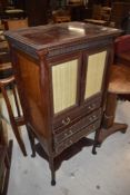 A Victorian mahogany music cabinet of interesting design with glazed cupboard section of three