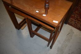 A vintage teak nest with castors
