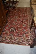 A traditional rug/carpet square in russet shades