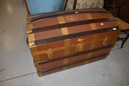 A vintage dome top travel trunk