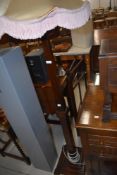 An early 20th Century oak standard lamp, Art Deco influences, having square column and stepped base