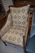 A 19th mahogany and inlaid easy chair , later upholstery