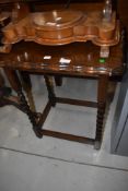 An early to mid 20th Century oak occasional table having twist frame