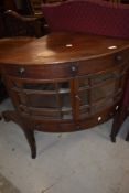 A period style low corner unit having drawers and glazed section