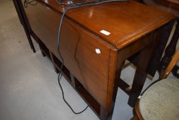 A traditional mahogany gateleg dining table