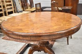 A Victorian tilt top tea table by Gillows of Lancaster having ornate parquetry veneer top with