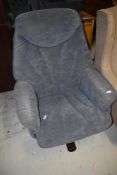A modern easy chair, in the vintage style with suedette upholstery
