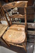 A Victorian bedroom chair having ply seat
