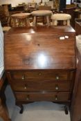 An early 20th century compact bureau chest of three drawers having fitted interior