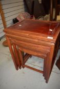 A nest of three hardwood oriental style tables