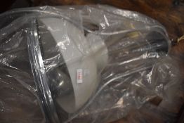 A large chrome ceiling light fitting and glass shade