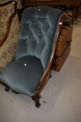 A 19th mahogany nursing chair having scroll frame and blue dralon upholstery with button back