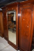 Victorian three section wardrobe having mahogany case with mirror door