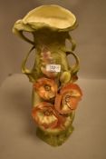 A continental pottery vase, of Art Nouveau design and decorated with flowers, foliage and seed