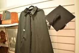 A 20th century graduation gown and mortar board cap