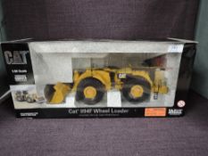 A Norscot 1:50 scale diecast CAT 994F Wheel Loader in yellow in polystyrene packaging and in