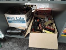 A shelf of playworn 0 gauge including Hornby tin plate wagons, scratch built clockwork 0-6-0
