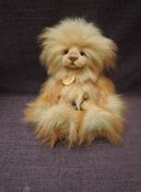 A Charlie Bears Jointed Teddy bear named Goldust having plastic eyes, stitched nose and mouth,