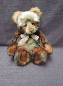 A Charlie Bears Jointed Teddy bear named Tigga having plastic eyes, stitched nose and mouth, two
