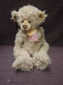 A Charlie Bears Jointed Teddy bear named Charlie 2010 having plastic eyes, stitched nose and
