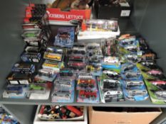 A shelf of 21st century diecasts including Maisto, Siku, Adventure Wheels etc, all in boxes or