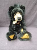 A Charlie Bears Jointed Teddy bear named Malcolm having plastic eyes, stitched nose and mouth, two