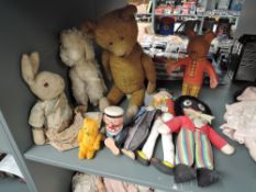 A mid 20th century yellow plush Teddy Bear having plastic eyes, stitched nose and mouth, jointed