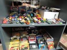 Two shelves of mainly 1980's and later diecasts including Matchbox, Corgi, Lledo, Cararama etc,