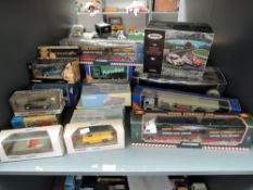 A shelf of modern Corgi and Dinky diecasts including Eddie Stobbart, Guinness, Mini 7, James Bond