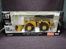 A Norscot 1:50 scale diecast CAT 994F Wheel Loader in yellow in polystyrene packaging and in