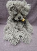 A Charlie Bears Jointed Teddy bear named Merlin having plastic eyes, stitched nose and mouth, grey