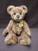 A Charlie Bears Jointed Teddy bear named Scribbles having plastic eyes, stitched nose and mouth, two