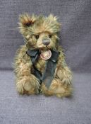 A Charlie Bears Jointed Teddy bear named Todd having plastic eyes, stitched nose and mouth, brown