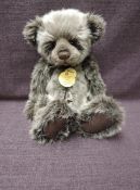 A Charlie Bears Jointed Teddy bear named Walker having plastic eyes, stitched nose and mouth, two