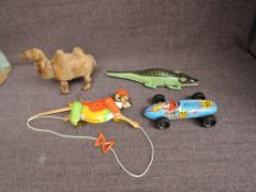 A Clockwork and Plush Camel, a tin plate and friction driven Japanese Racing Car, a reproduction tin