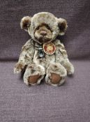 A Charlie Bears Jointed Teddy bear named Jooles having plastic eyes, stitched nose and mouth, two