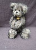 A Charlie Bears Jointed Teddy bear named Willis having plastic eyes, stitched nose and mouth, two