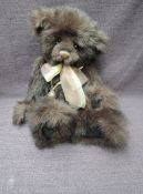 A Charlie Bears Jointed Teddy bear named Cody having plastic eyes, stitched nose and mouth, brown