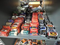 A shelf of modern diecasts including Mattel Cameo, Realtoy Action City, Welly, Tesco Fuel Line