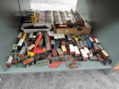 A shelf of 00 gauge Rolling Stock, mainly Hornby, various condition and repair, 70+ items