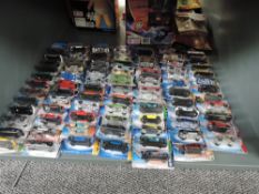 A shelf of 21st century Mattel Hot Wheels diecasts, mainly 2006 onwards, all in blister packs,