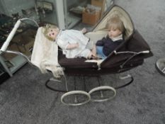 A Silver Cross Pram having double spoke wheels on suspension frame, brown body and hood with cream