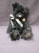 A Charlie Bears Jointed Teddy bear named Eddie having plastic eyes, stitched nose and mouth, black