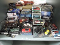 A shelf of modern diecasts including GE Fabbri James Bond, MiniChamps Red Bull Racing Car, Cararama,
