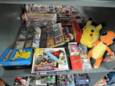 A shelf of modern Pokemon collectables including Nintendo Pikachu and Charmanda soft toys both