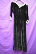 A late 1930s black velvet dress having intricate lace to cuffs and collar, side brass zip,in a