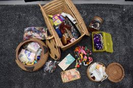 Two sewing baskets containing a selection of embroidery threads and haberdashery.