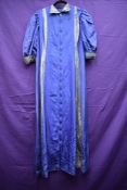 A 1930s purple taffetta house coat, having long zip to front(thought to be a later addition) and